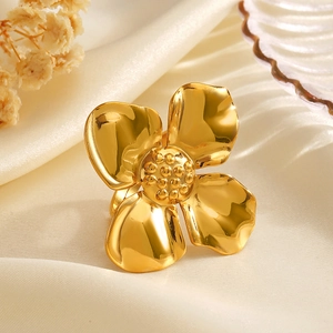 Exaggerated 18K gold plated stainless steel oversized flower ring on silk fabric