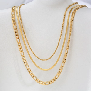 Detail of layered golden stainless steel necklaces with Figaro, herringbone, and rope chains