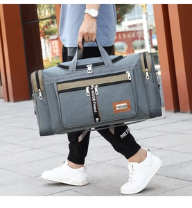 Detail shot of the durable grey Oxford fabric and woven straps on the travel gym bag