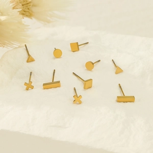 Minimalist geometric gold earring set featuring five shapes on a marble stone base