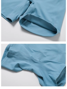 Close-up of flatlock stitching and ergonomic seams on light blue yoga shorts