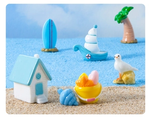Miniature beach theme set with a blue cottage, sailboat, and palm tree for DIY decor