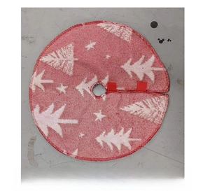 Detail of red knitted Christmas tree skirt with white tree patterns and red ribbon ties