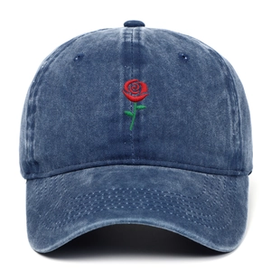 Close-up of red rose embroidery on a vintage washed navy blue cotton baseball cap