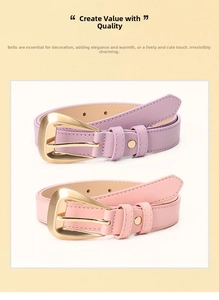 Close-up of pink and purple faux leather belts with large golden triangle buckles