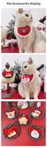 Detailed view of handmade knitted Christmas pet bibs with Santa and reindeer patterns