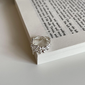 Minimalist 925 sterling silver irregular ring with metal chain on book pages