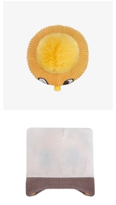 Detailed close-up of thick knit winter hats with large pom-poms and cartoon eye designs