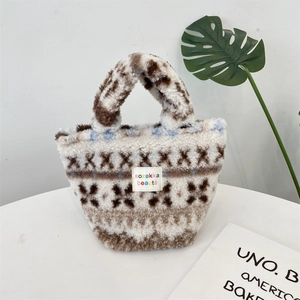 Detailed close-up of fluffy tote bag featuring Fair Isle patterns and embroidered label