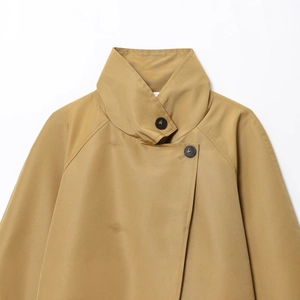 Minimalist khaki cropped trench coat with large black buttons and high-quality flat-weave texture