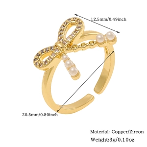 Detail of gold bow ring with zircon and pearl detailing technical size specifications