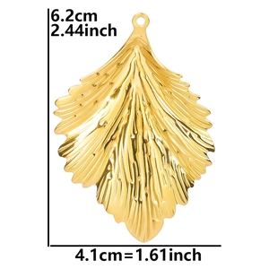 Detailed view of leaf pendant with dimensions 6.2x4.1cm and polished 18k gold plating texture