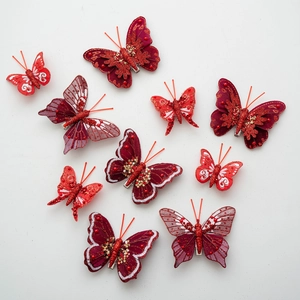 Set of decorative red feather butterflies with sequins and glitter for Christmas decor
