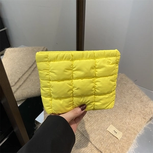 Chic yellow quilted puffer clutch bag with stylish checkered down-filled texture