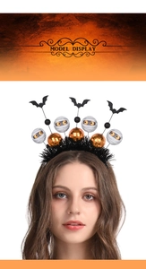 Detail of Halloween headband with black bats and decorative mummy balls on metal springs
