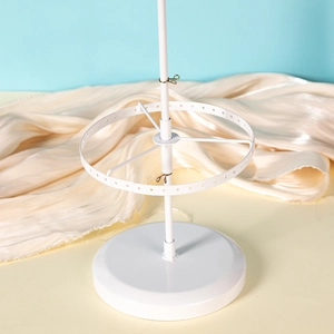 Close-up of a white adjustable rotating jewelry stand for earrings and necklaces