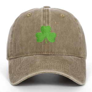 Detail of green clover embroidery on vintage washed canvas baseball cap fabric