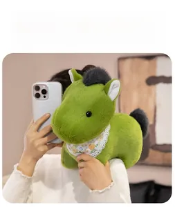 Close-up of cute green plush pony toy with floral scarf shown in a selfie style