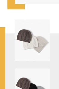Detail view of multi-colored cable knit beanies in brown, beige, white, and grey