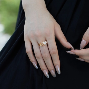 Detail of S925 silver ring featuring a golden heart-shaped gem and letter L with zircon