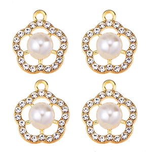 Detailed view of four gold flower pendants with white pearls and sparkling cubic zirconia
