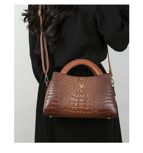 Detailed macro view of the brown crocodile pattern PU leather and golden V-shaped buckle
