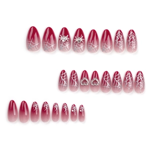 Red gradient press-on nails with silver spider web patterns and 3D heart charms