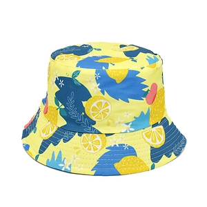 Close-up of lemon print detail on canvas bucket hat with vibrant tropical fruit patterns