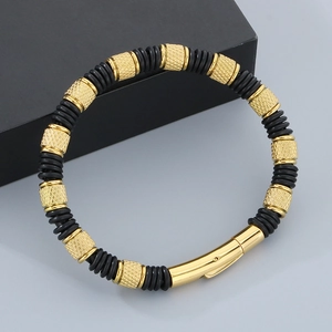 Close-up of black textured silicone and gold metal blocks on men's fashion bracelet