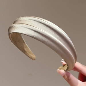 Champagne gold padded headband with elegant textured fabric for a high crown effect