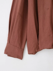 Detailed macro view of rust brown suede jacket cuffs and hem showing high-quality stitching