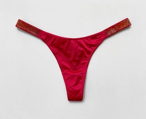 Close-up of pink satin thong featuring rhinestone side straps for fitness and style