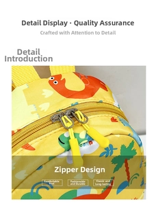 Close-up of dual metal zippers and colorful dinosaur patterns on yellow kids' backpack