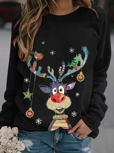 Detailed close-up of festive reindeer and snowflake print on a black long sleeve tee