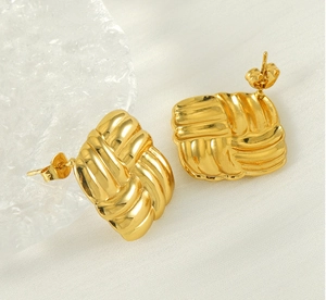 Macro detail of square textured 18K gold stainless steel earrings with weave pattern