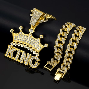 Detail of gold-plated KING crown pendant oniced out Cuban chain with sparkling rhinestones