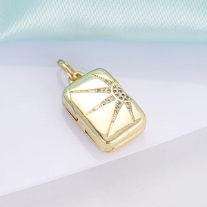 Macro shot of 18K gold plated sunray locket pendant with sparkling zircon accents