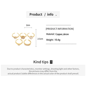 Detailed view of 5-piece gold-tone copper ring set featuring clear cubic zirconia accents