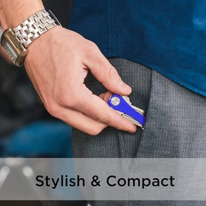 Blue compact aluminum key organizer shown being tucked into a business suit pocket