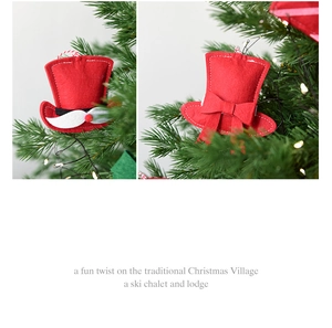 Detail of red felt Christmas hat ornaments with white beard and bow on green tree