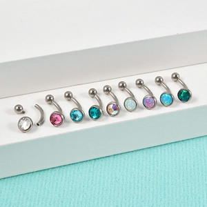 Detailed macro view of G23 titanium eyebrow rings with colorful opal and zircon settings