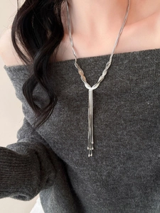 Close-up of a silver multi-layer tassel Y-necklace with elegant snake chain details