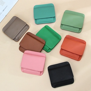 Mini genuine leather coin purses in multiple colors with lychee grain texture flat lay