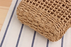 Close-up of the natural woven paper rope texture and hollow mesh on a beach bag