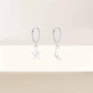 Detailed view of S925 silver hoop earrings featuring sparkling star and crescent moon pendants