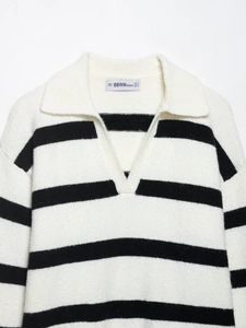 Close-up of the polo collar and V-neckline of a striped knit sweater with soft texture