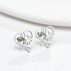 Minimalist silver stainless steel heart music note stud earrings on white background