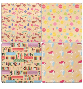 Detail showing four assorted birthday wrapping paper patterns with balloons and unicorns