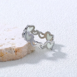Detailed side view of 304 stainless steel luminous heart ring on a natural stone surface