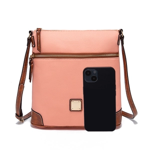Detail of pink pebbled leather crossbody bag with brown trim and gold hardware accents